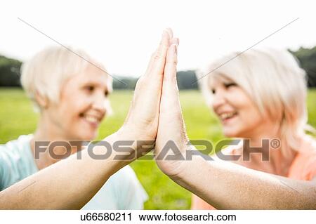 Two women with hands touching View Large Photo Image Stock Image - Two women with hands touching. Fotosearch