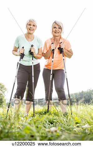Two women with walking poles View Large Photo Image Stock Photography - Two women with walking poles. Fotosearch