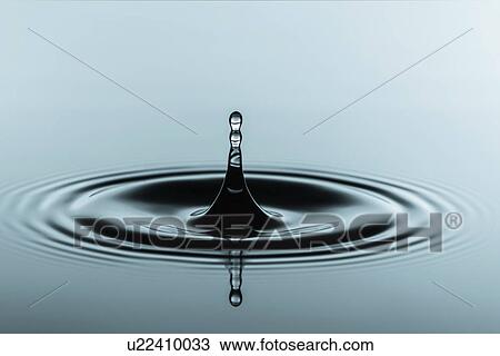 Stock Image - Water droplet on water surface.. Fotosearch