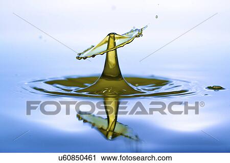 Stock Image - Water droplet on water surface.. Fotosearch