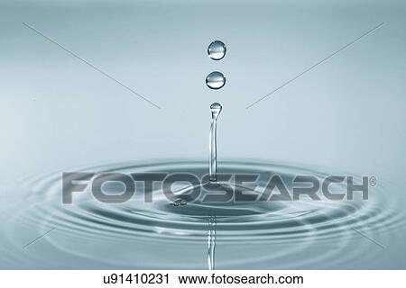Stock Image - Water droplet on water surface.. Fotosearch