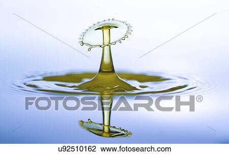Stock Image - Water droplet on water surface.. Fotosearch