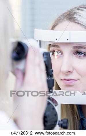 Stock Image - Woman having eye examination. Fotosearch