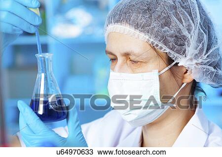 Woman holding flask in chemical laboratory View Large Photo Image Stock Image - Woman holding flask in chemical laboratory. Fotosearch