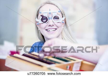Stock Photography - Woman wearing trial frame. Fotosearch