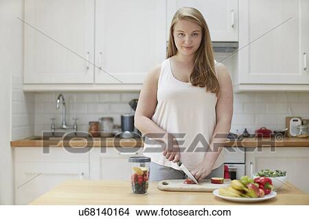 Young woman preparing healthy food in kitchen View Large Photo Image Picture - Young woman preparing healthy food in kitchen. Fotosearch