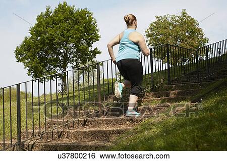 Young woman running up steps View Large Photo Image Stock Photograph - Young woman running up steps. Fotosearch