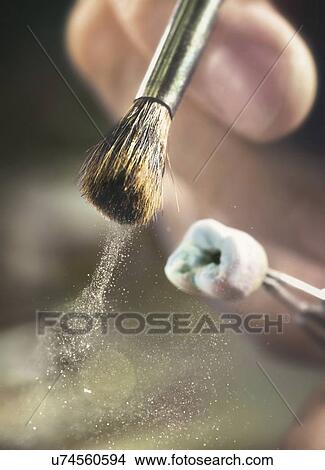 Person brushing prosthetic tooth, close up. View Large Photo Image Picture - Person brushing prosthetic tooth, close up.. Fotosearch