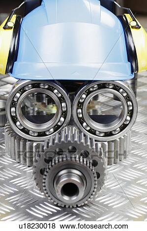 Stock Photo - Anthropomorphic mechanical parts and hard hat. Fotosearch
