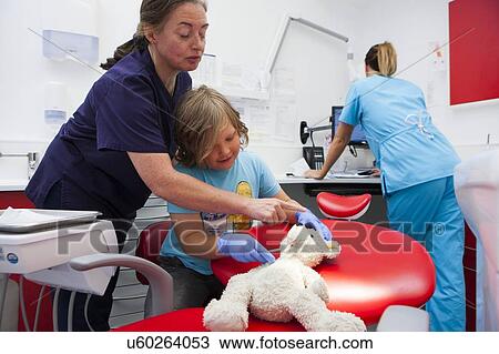 Stock Image - Child at dentist's. Fotosearch