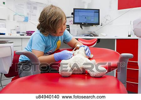 Stock Image - Child at dentist's. Fotosearch