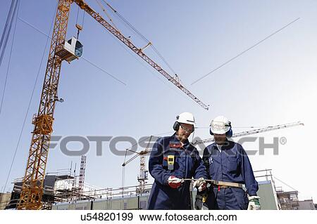 Stock Photo - Construction workers on site. Fotosearch