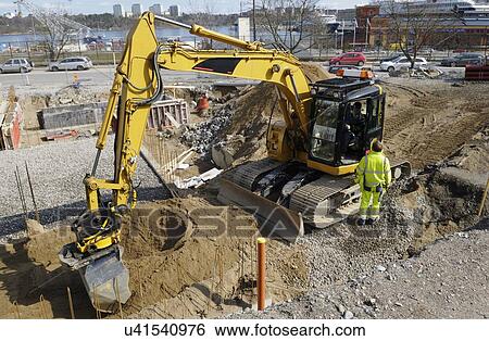 Digger on construction site View Large Photo Image Stock Photograph - Digger on construction site. Fotosearch