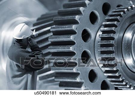Stock Image - Engineer and industrial cogs. Fotosearch