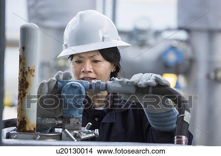 Picture - Female engineer working at power plant. Fotosearch
