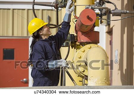 Picture - Female engineer working at power plant. Fotosearch
