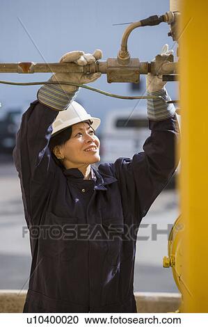 Stock Image - Female engineer working at power plant. Fotosearch