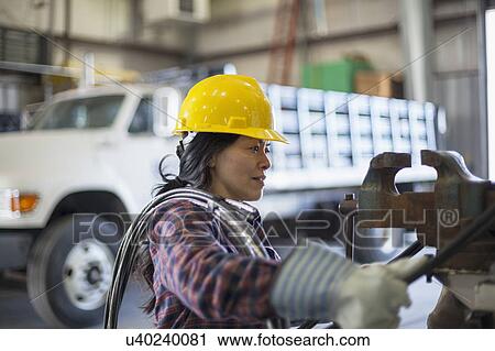 Stock Image - Female engineer working at power plant. Fotosearch