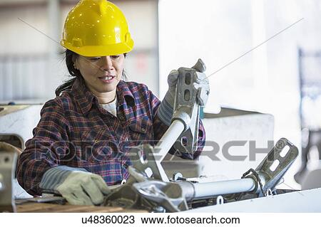 Stock Image - Female engineer working at power plant. Fotosearch