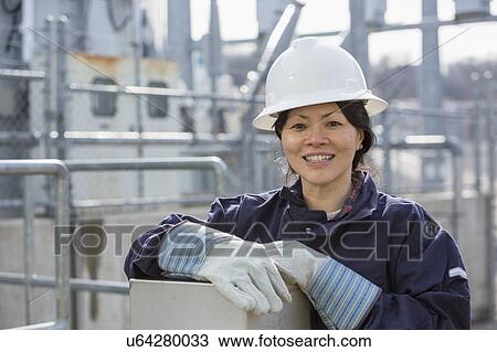 Stock Image - Female engineer working at power plant. Fotosearch
