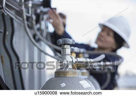 Stock Photo - Female engineer working at power plant. Fotosearch