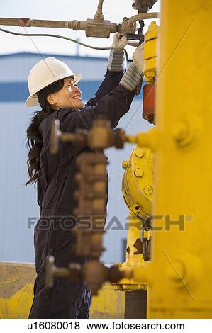 Stock Photo - Female engineer working at power plant. Fotosearch