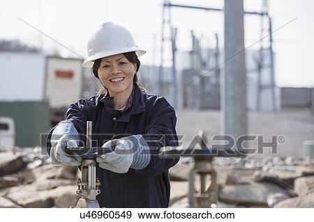 Stock Photo - Female engineer working at power plant. Fotosearch