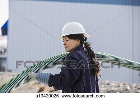 Stock Photograph - Female engineer working at power plant. Fotosearch