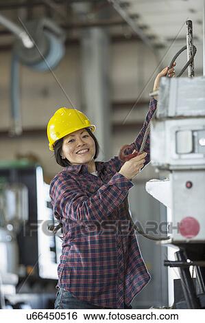 Stock Photograph - Female engineer working at power plant. Fotosearch