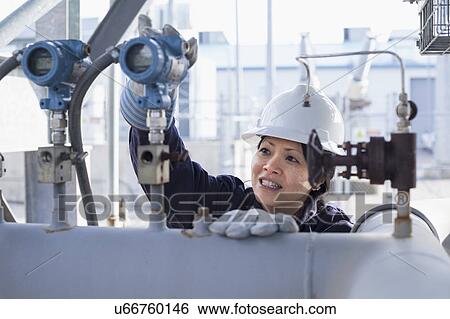Stock Photograph - Female engineer working at power plant. Fotosearch