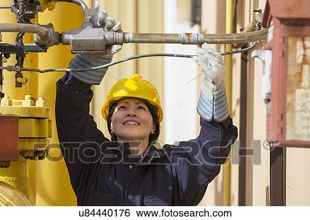 Stock Photograph - Female engineer working at power plant. Fotosearch