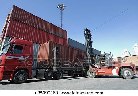 Forklift truck lifting shipping container View Large Photo Image Stock Photo - Forklift truck lifting shipping container. Fotosearch
