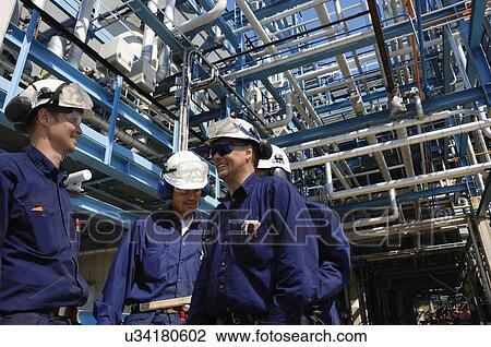 Industrial workers on oil and gas refinery View Large Photo Image Stock Image - Industrial workers on oil and gas refinery. Fotosearch
