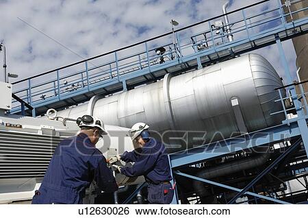 Industrial workers on oil and gas refinery View Large Photo Image Stock Photograph - Industrial workers on oil and gas refinery. Fotosearch