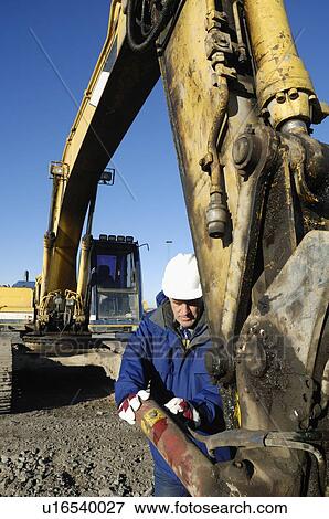 Stock Photo - Man operating bulldozer. Fotosearch