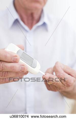 Man testing glucose View Large Photo Image Picture - Man testing glucose. Fotosearch