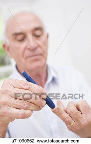 Man testing glucose View Large Photo Image Stock Image - Man testing glucose. Fotosearch