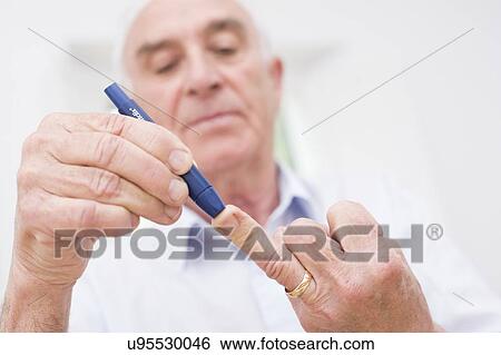 Man testing glucose View Large Photo Image Stock Photograph - Man testing glucose. Fotosearch