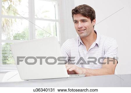 Man using laptop View Large Photo Image Stock Image - Man using laptop. Fotosearch