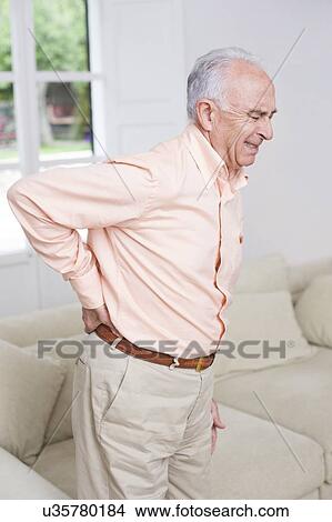 Picture - Man with back pain. Fotosearch