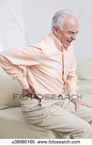 Stock Photograph - Man with back pain. Fotosearch