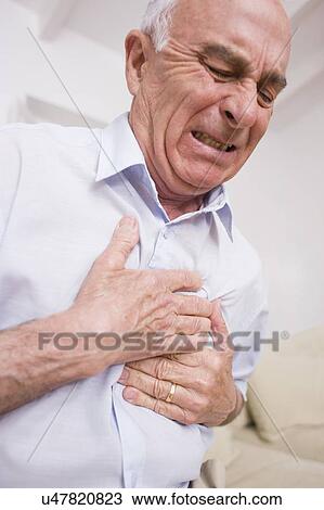 Stock Image - Man with chest pain. Fotosearch