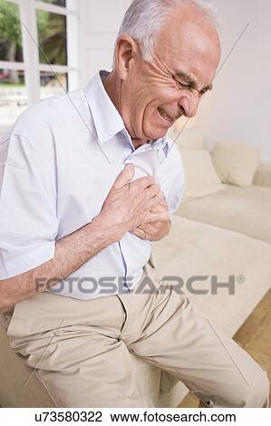 Stock Image - Man with chest pain. Fotosearch