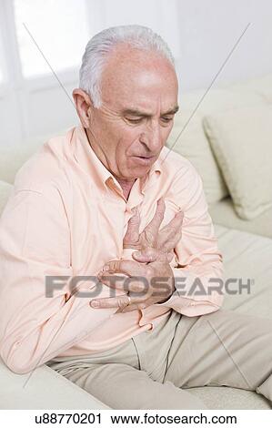 Stock Image - Man with chest pain. Fotosearch
