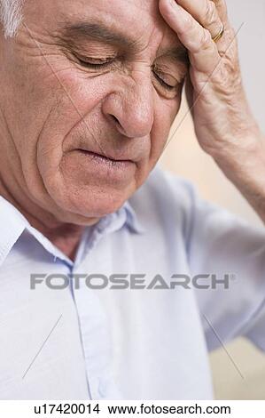Picture - Man with headache. Fotosearch