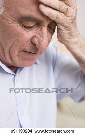 Picture - Man with headache. Fotosearch