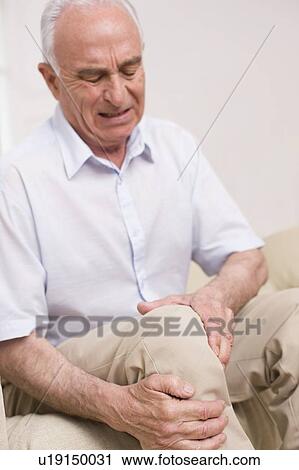 Stock Image - Man with knee pain. Fotosearch