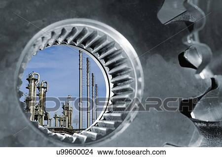 Picture - Oil refinery seen through industrial gears. Fotosearch