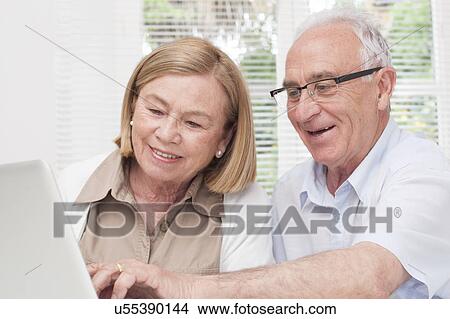 Picture - Senior couple using laptop. Fotosearch