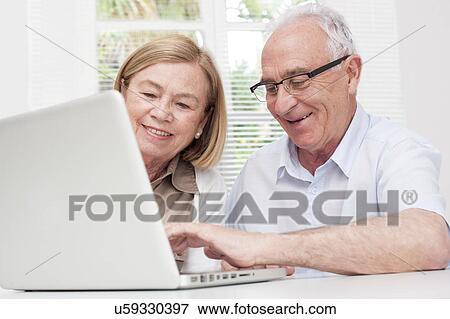 Stock Photo - Senior couple using laptop. Fotosearch